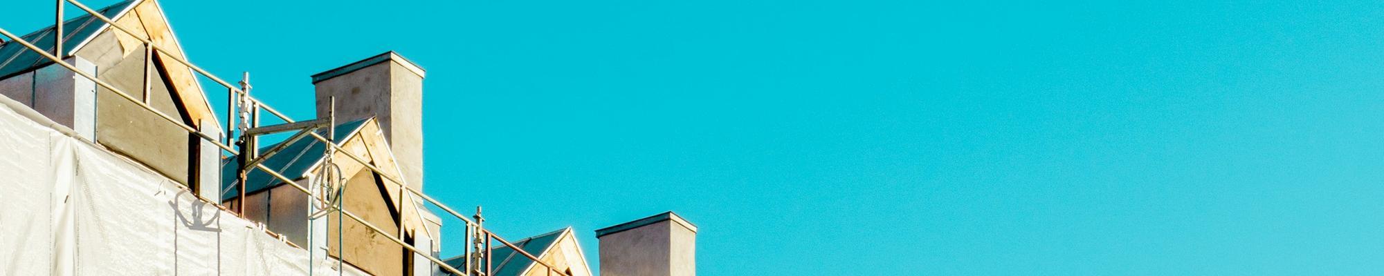 Photo of a few rooftops and blue sky